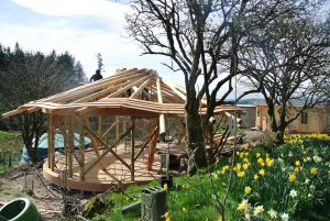 The roof frame is now complete and the sarking boards are going on - beautiful April day in North Wales!