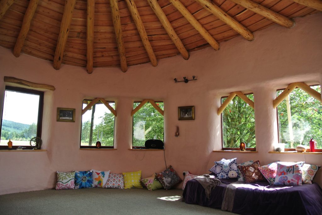 Sunny outside....warm and pink inside! Ty Mam Mawr straw bale roundhouse