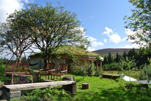 The fire pit and roundhouse at Ty Mam Mawr off grid eco retreat centre