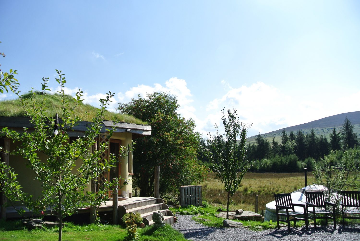 The roundhouse and Ty Crwn Mawr at the intimate off grid eco retreat centre Ty Mam Mawr